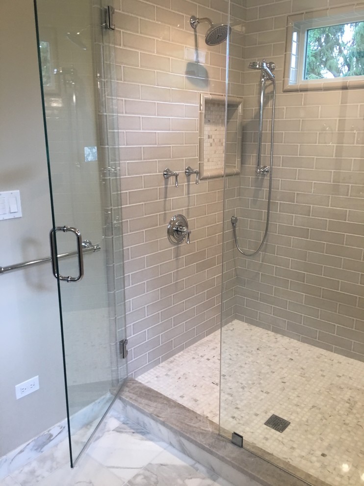 This is an example of a large traditional master bathroom in Chicago with recessed-panel cabinets, dark wood cabinets, beige tile, subway tile, beige walls, marble floors and quartzite benchtops.