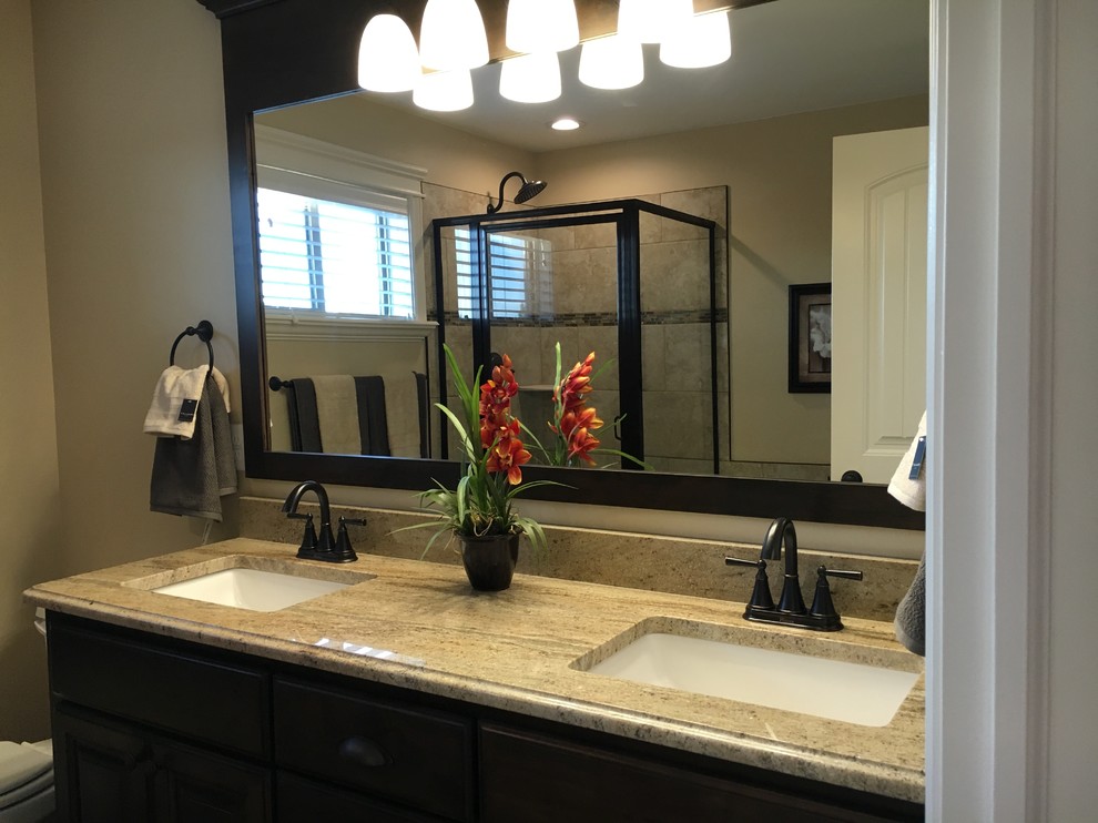 Alcove shower - mid-sized transitional master beige tile and porcelain tile porcelain tile alcove shower idea with raised-panel cabinets, dark wood cabinets, an undermount tub, a two-piece toilet, beige walls, an undermount sink and granite countertops
