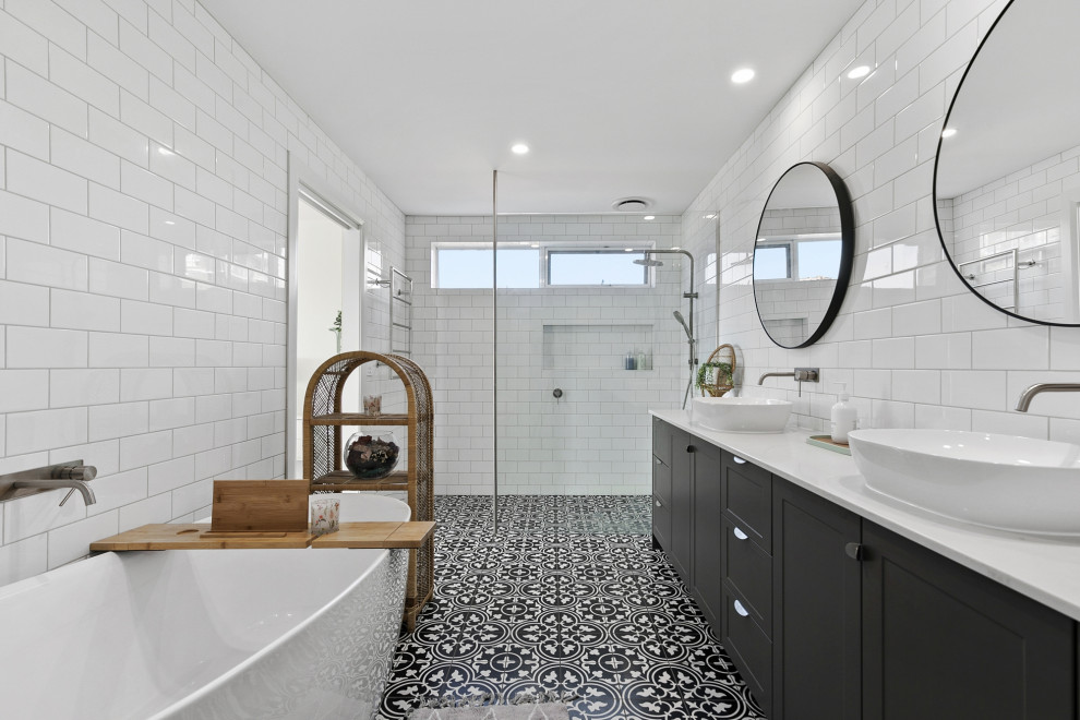 This is an example of a large transitional master bathroom in Geelong with shaker cabinets, a freestanding tub, an open shower, ceramic floors, engineered quartz benchtops, an open shower, a niche, a double vanity and a built-in vanity.