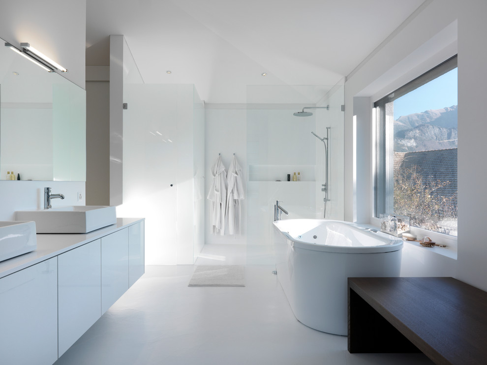 Design ideas for a contemporary master bathroom in Other with a vessel sink, flat-panel cabinets, white cabinets, a freestanding tub, a curbless shower and white walls.
