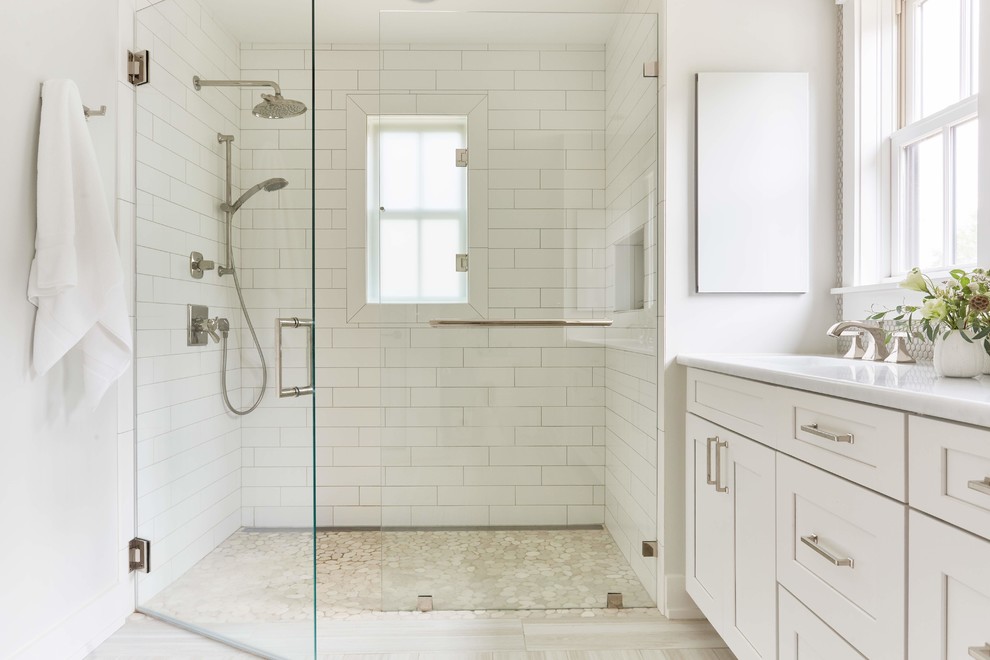 Large country master bathroom in Richmond with shaker cabinets, white cabinets, an alcove shower, a two-piece toilet, white tile, mosaic tile, white walls, light hardwood floors, an undermount sink, quartzite benchtops, beige floor, a hinged shower door and white benchtops.