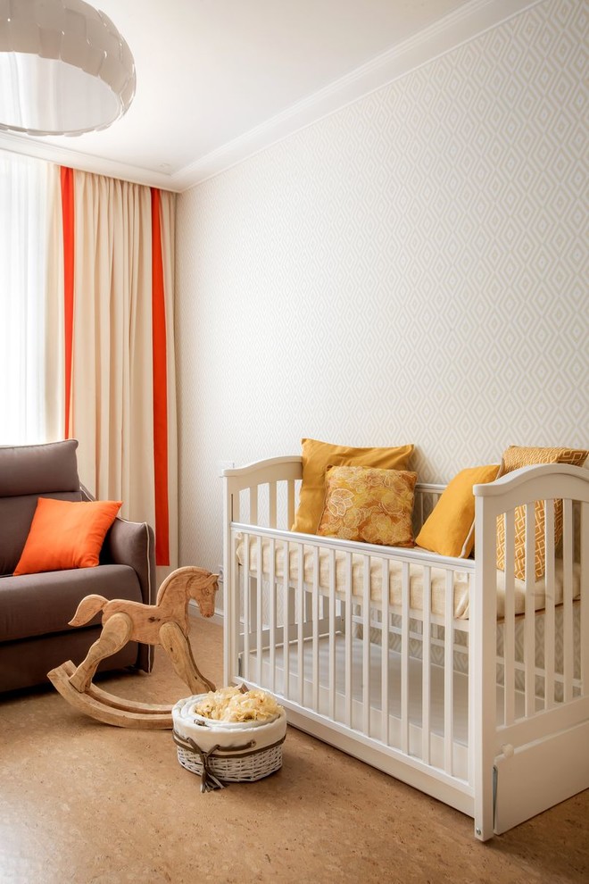 Photo of a mid-sized transitional gender-neutral nursery in Other with white walls, cork floors and beige floor.