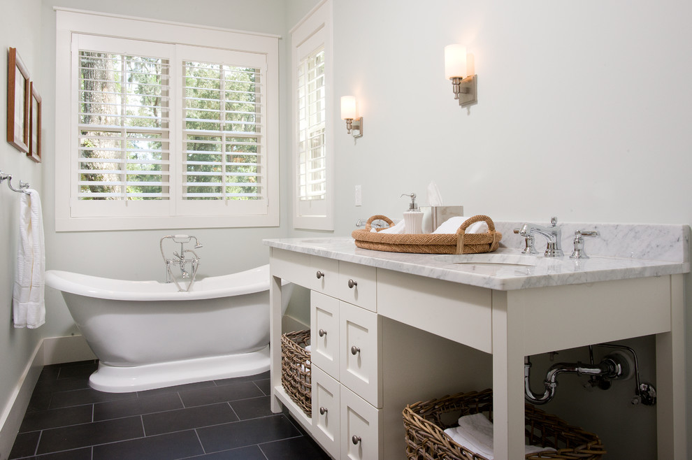 This is an example of a country master bathroom in Atlanta with an undermount sink, flat-panel cabinets, white cabinets, marble benchtops, a freestanding tub, black tile, ceramic tile, blue walls and ceramic floors.