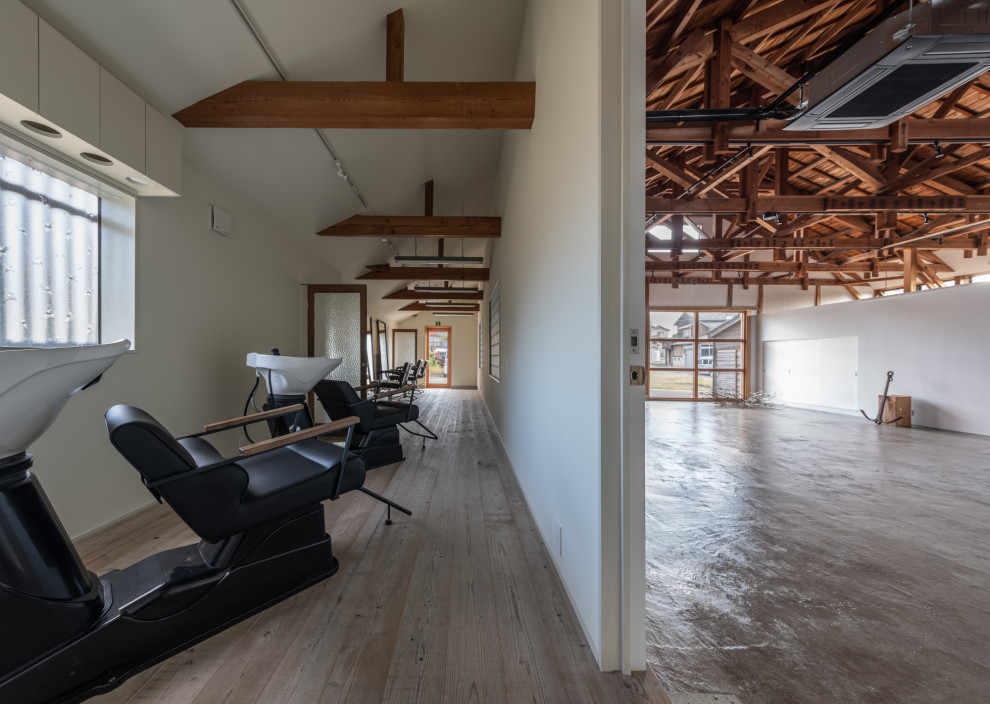 Inspiration for a mid-sized industrial concrete floor, gray floor and exposed beam home studio remodel in Other with white walls