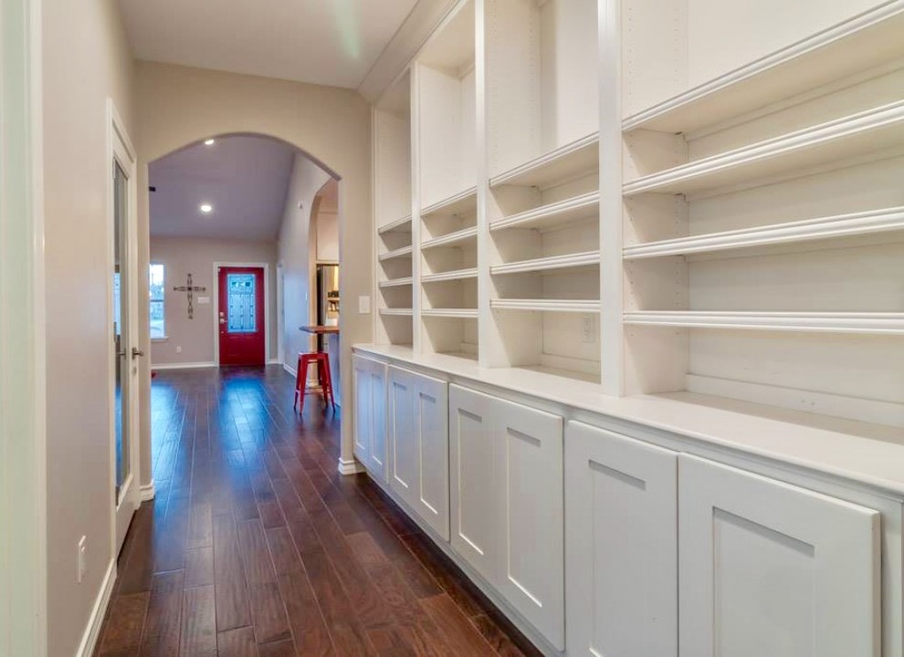 Example of a mid-sized transitional dark wood floor and brown floor hallway design in Austin with beige walls