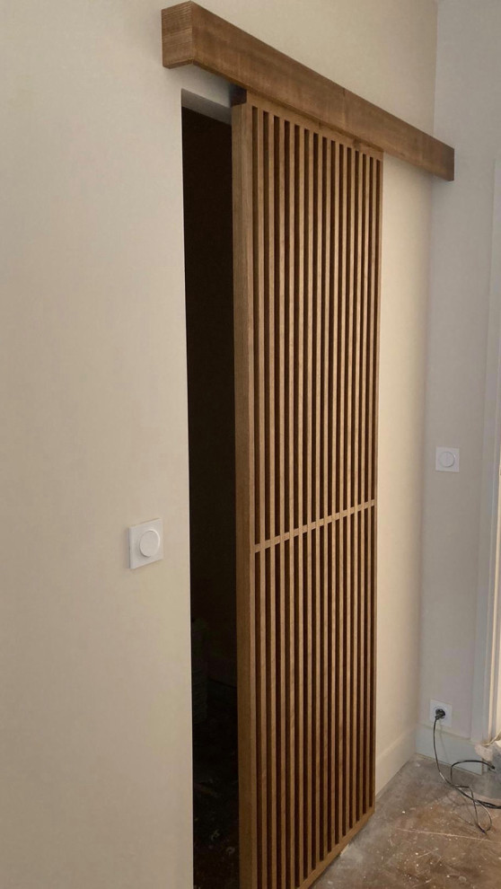 Mid-sized trendy gender-neutral walk-in closet photo in Paris with louvered cabinets