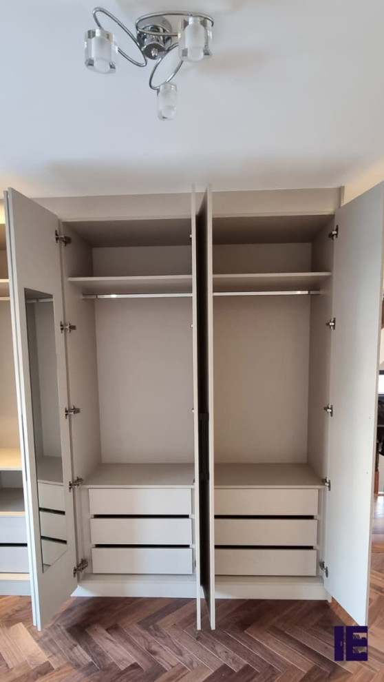 Inspiration for a small modern storage and wardrobe in London with flat-panel cabinets, grey cabinets, plywood floors and wood.