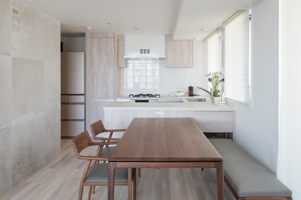 Inspiration for a small modern kitchen in Tokyo with an integrated sink, painted wood floors, a peninsula and grey floor.