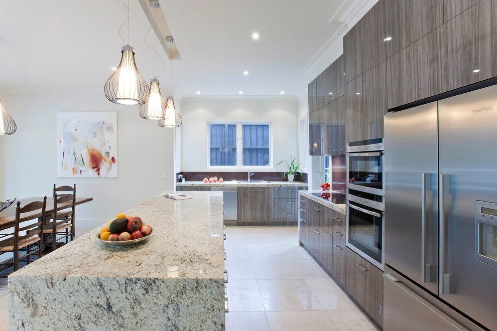 Inspiration for a large contemporary open plan kitchen in Melbourne with a submerged sink, flat-panel cabinets, medium wood cabinets, granite worktops, red splashback, glass sheet splashback, stainless steel appliances, porcelain flooring and an island.
