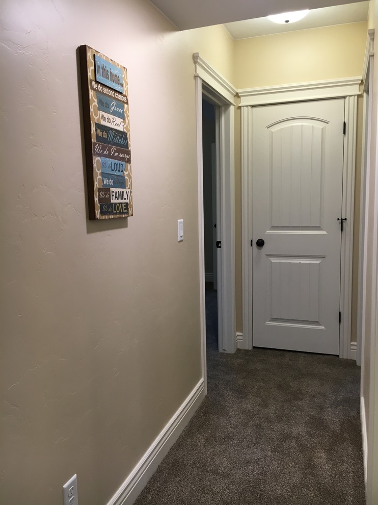 Small transitional carpeted hallway photo with beige walls