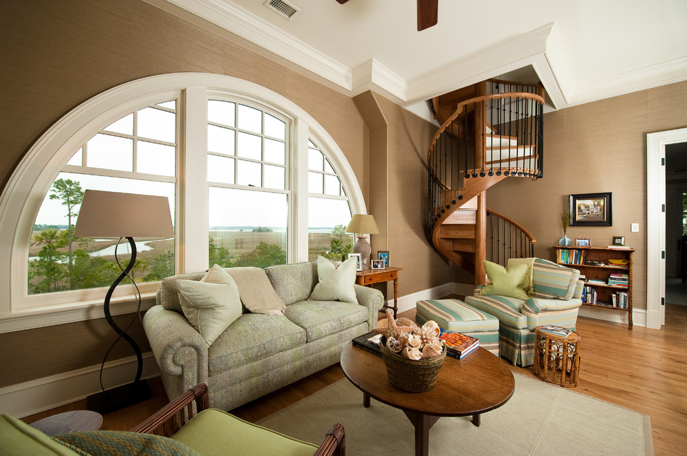 Design ideas for a traditional enclosed living room in Charleston with beige walls and light hardwood floors.