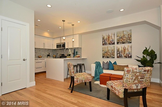 Transitional u-shaped light wood floor eat-in kitchen photo in DC Metro with an undermount sink, flat-panel cabinets, white cabinets, quartz countertops, multicolored backsplash, mosaic tile backsplash, stainless steel appliances and a peninsula
