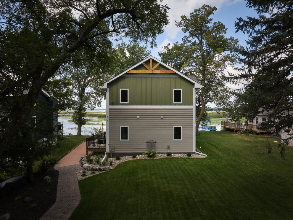 Large transitional multicolored two-story vinyl and board and batten gable roof photo in Minneapolis with a shingle roof and a black roof
