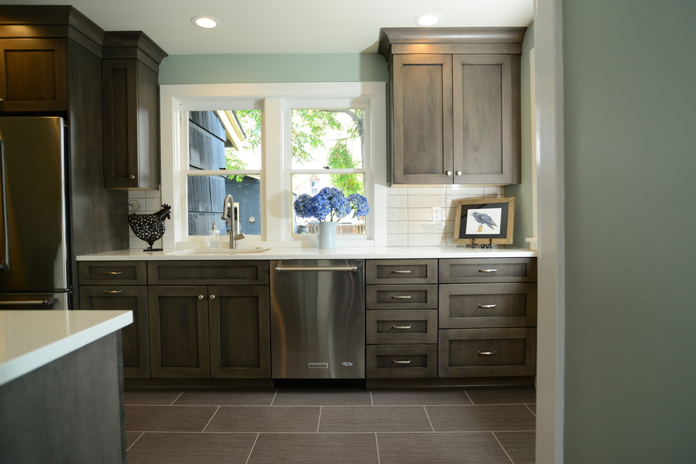 Example of a mid-sized transitional galley vinyl floor eat-in kitchen design in Seattle with an undermount sink, shaker cabinets, white cabinets, quartz countertops, white backsplash, cement tile backsplash, stainless steel appliances and no island