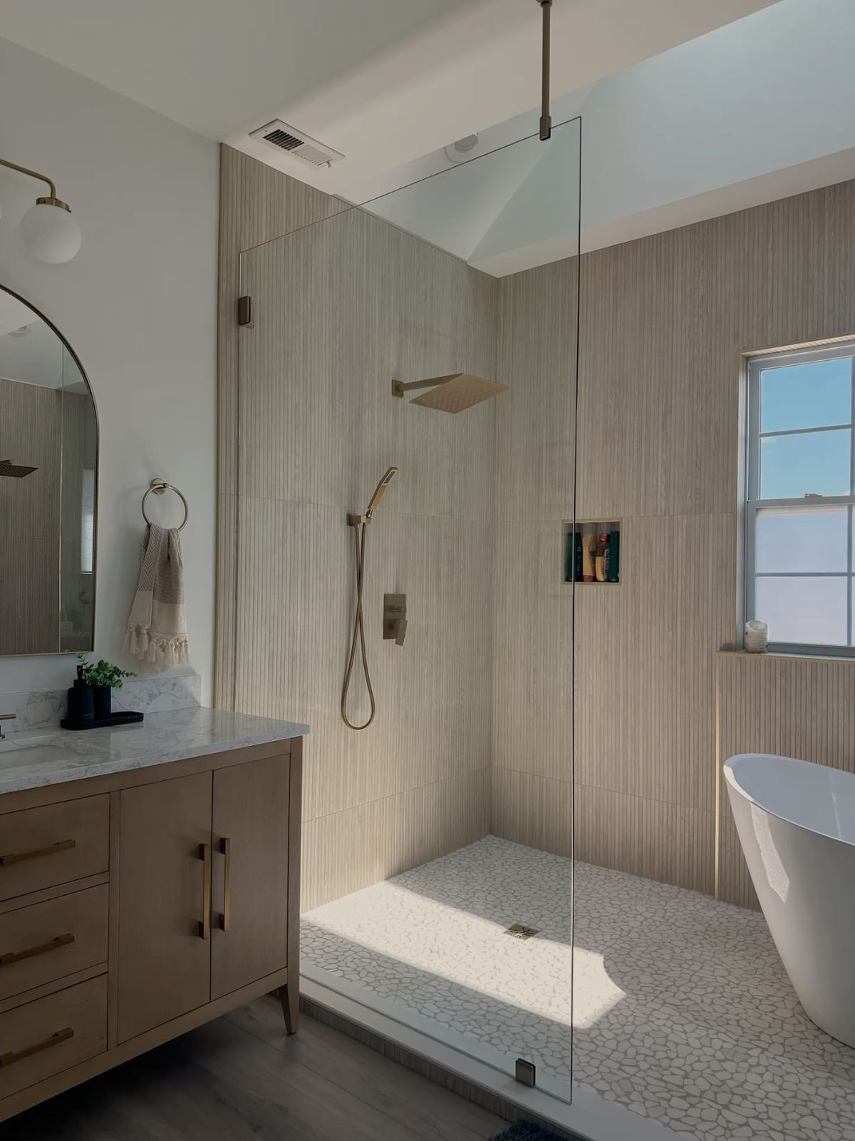 Remodeled Bathroom with free standing tub and natural colors
