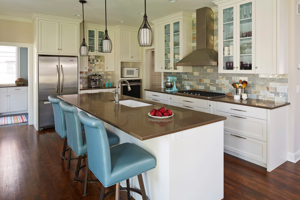 Mid-sized transitional l-shaped dark wood floor kitchen photo in Minneapolis with an undermount sink, flat-panel cabinets, white cabinets, quartz countertops, multicolored backsplash, glass tile backsplash, stainless steel appliances and an island