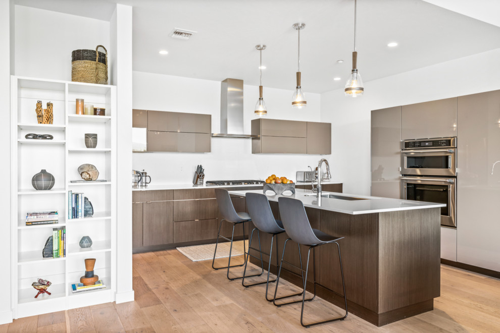 Example of an eclectic kitchen design with an island