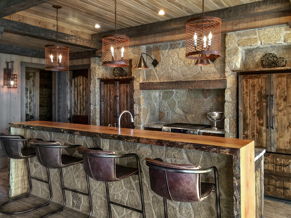 Design ideas for a mid-sized country galley seated home bar in Detroit with dark wood cabinets.