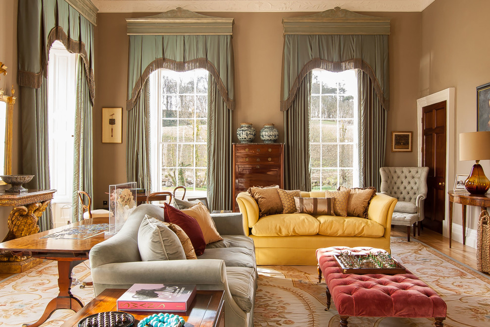 Inspiration for a traditional enclosed living room in London with brown walls and light hardwood floors.