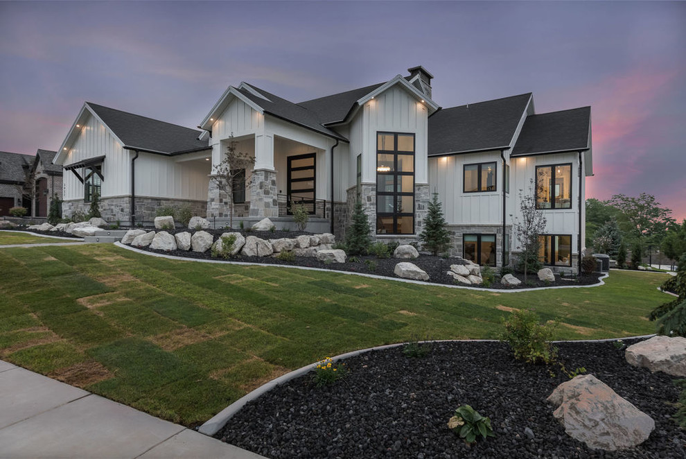 Inspiration for a large transitional one-storey black house exterior in Salt Lake City with stone veneer, a gable roof and a shingle roof.