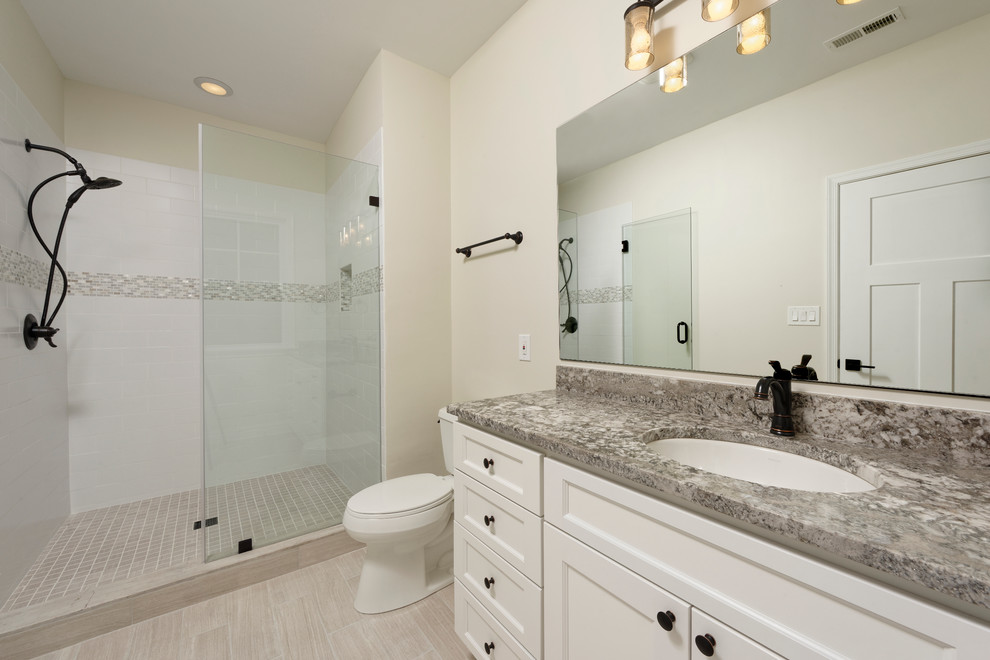 Inspiration for a large arts and crafts bathroom in DC Metro with a drop-in sink, shaker cabinets, white cabinets, granite benchtops, an open shower, a two-piece toilet, beige tile, ceramic tile, beige walls, ceramic floors, beige floor and a sliding shower screen.