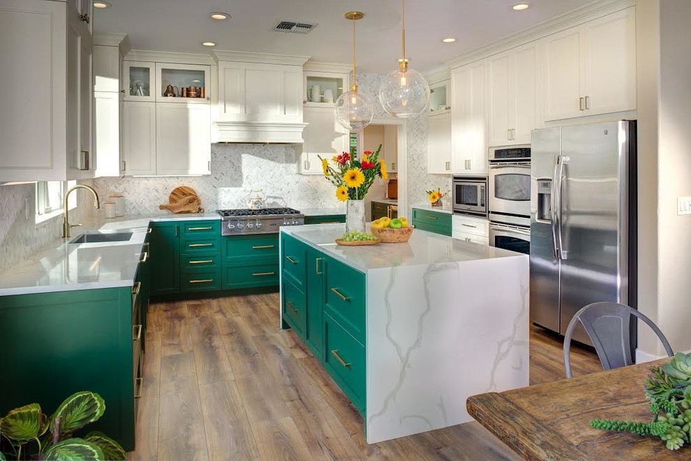 Mid-sized transitional l-shaped medium tone wood floor and brown floor eat-in kitchen photo in Sacramento with green cabinets, gray backsplash, an island, an undermount sink, stainless steel appliances, shaker cabinets, quartz countertops, porcelain backsplash and white countertops