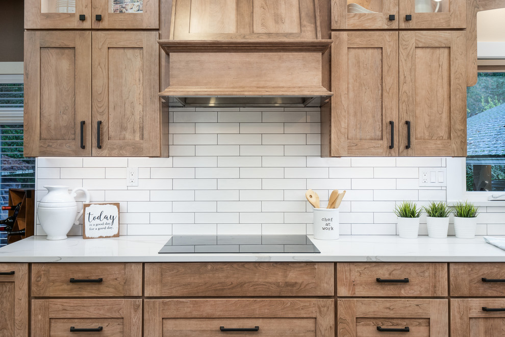 Large transitional l-shaped medium tone wood floor and brown floor open concept kitchen photo in Seattle with an undermount sink, shaker cabinets, light wood cabinets, quartz countertops, white backsplash, porcelain backsplash, stainless steel appliances, an island and white countertops