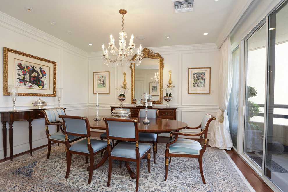 Traditional dining room in Houston with white walls and dark hardwood floors.