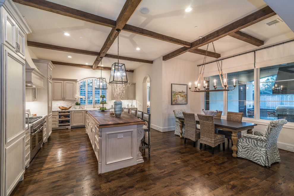 Photo of a mid-sized country l-shaped separate kitchen with a farmhouse sink, beaded inset cabinets, grey cabinets, granite benchtops, multi-coloured splashback, stainless steel appliances, medium hardwood floors and with island.