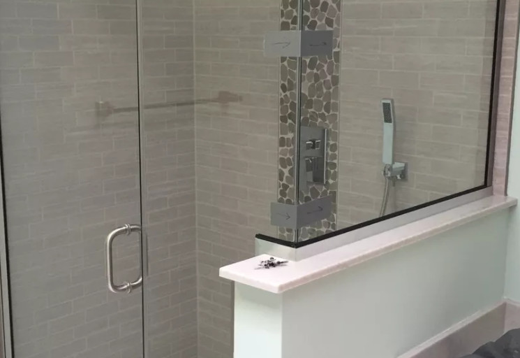 Example of a small transitional 3/4 beige tile and subway tile corner shower design with a one-piece toilet, white walls and a hinged shower door