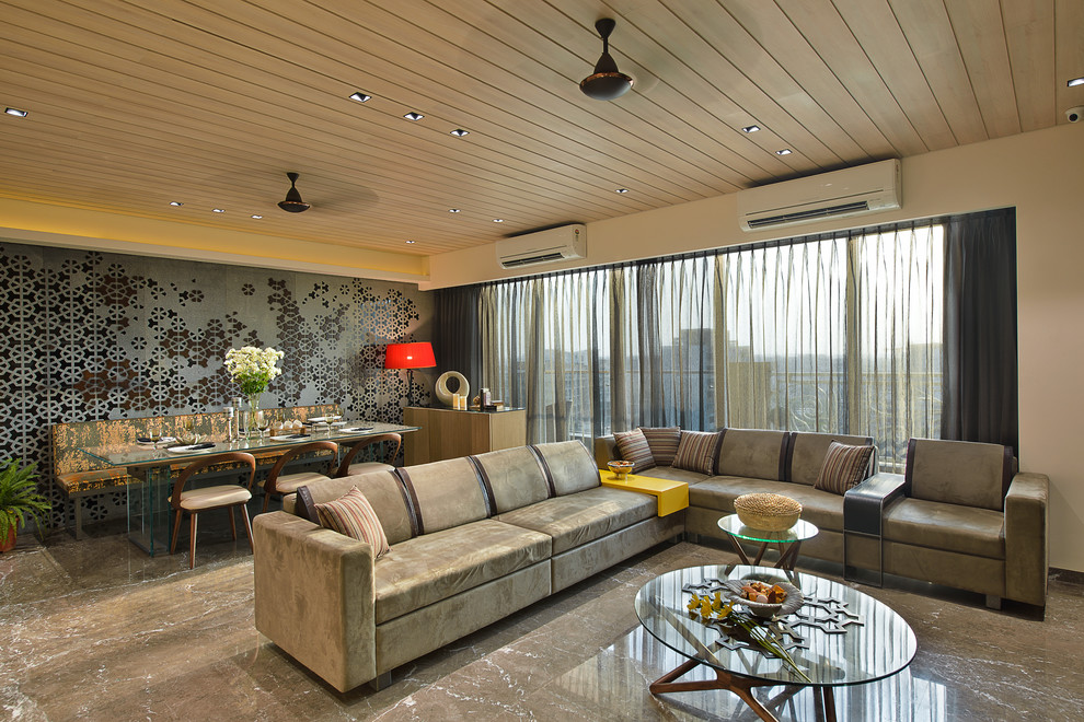 Contemporary living room in Mumbai with no fireplace and beige walls.