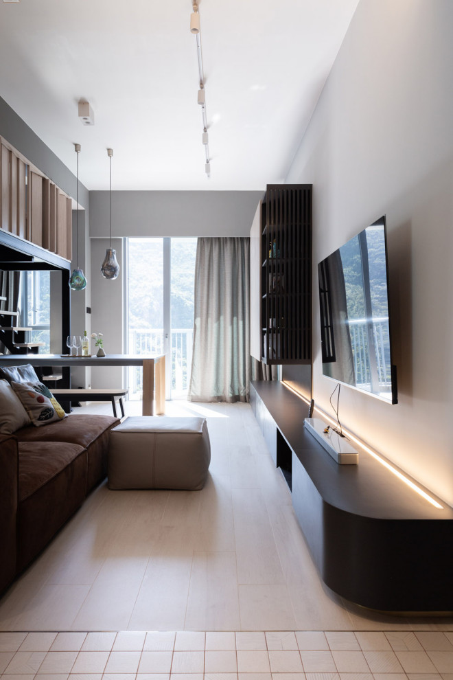 Small contemporary living room in Hong Kong with grey walls, ceramic floors, a wall-mounted tv and beige floor.