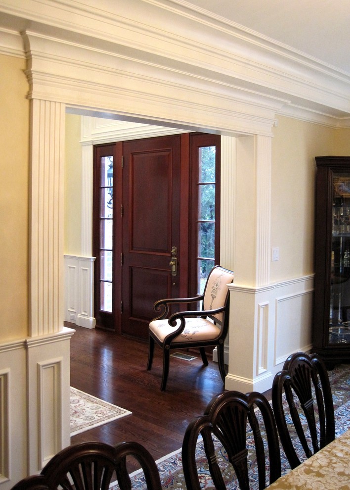 Large traditional separate dining room in Boston with beige walls, dark hardwood floors and brown floor.