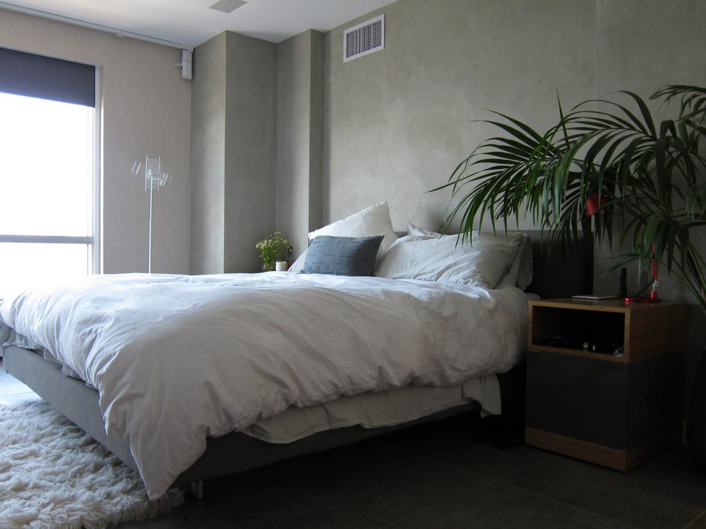 Photo of a small modern master bedroom in New York with beige walls, light hardwood floors and no fireplace.