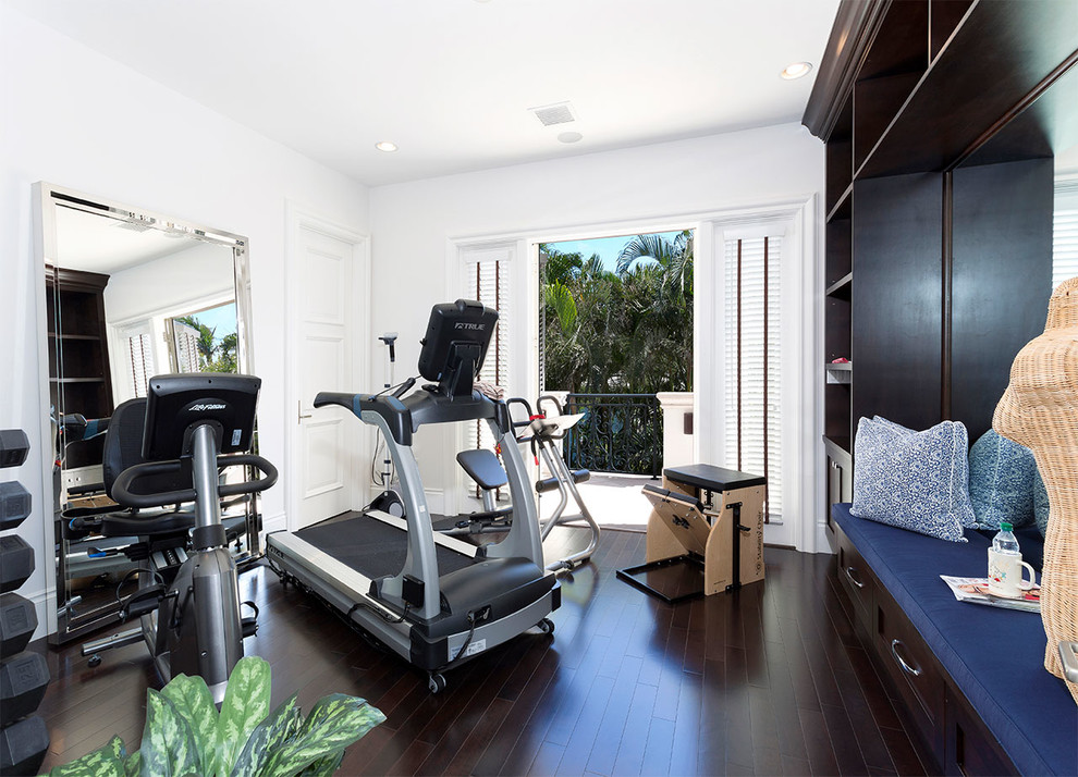 Inspiration for a mediterranean multipurpose gym in Other with white walls, dark hardwood floors and brown floor.