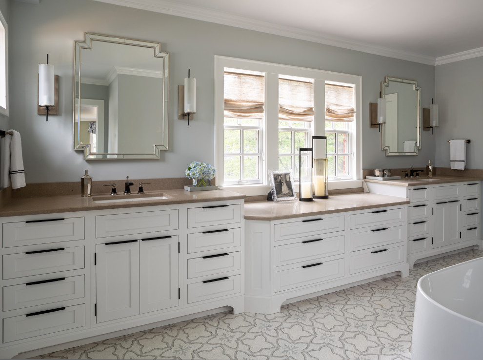 Design ideas for a large transitional master wet room bathroom in Chicago with recessed-panel cabinets, white cabinets, a freestanding tub, grey walls, mosaic tile floors, a drop-in sink, solid surface benchtops, white floor and brown benchtops.
