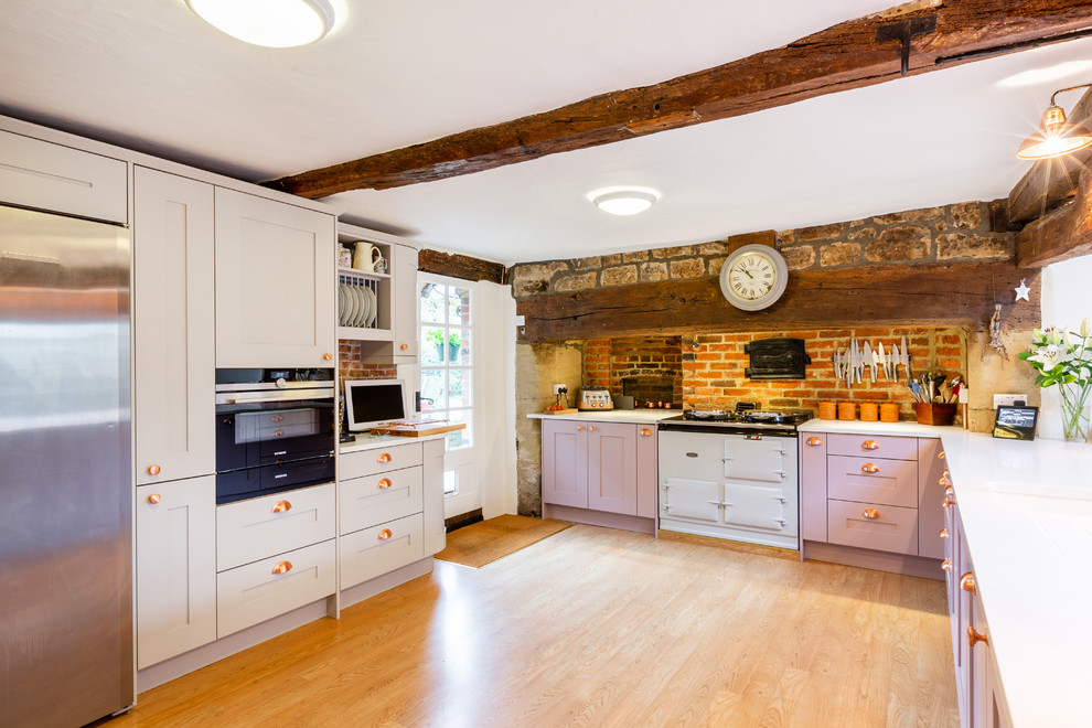 Inspiration for a country l-shaped open plan kitchen in Sussex with shaker cabinets, purple cabinets, quartzite benchtops and white benchtop.