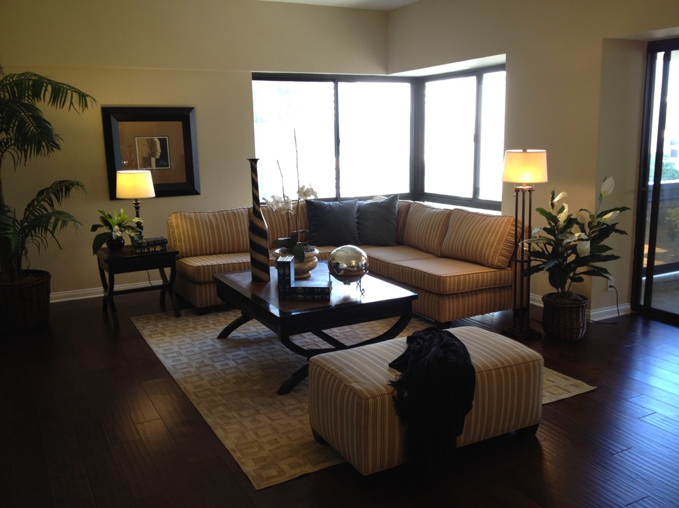 Photo of a small transitional loft-style living room in Orange County with beige walls and dark hardwood floors.