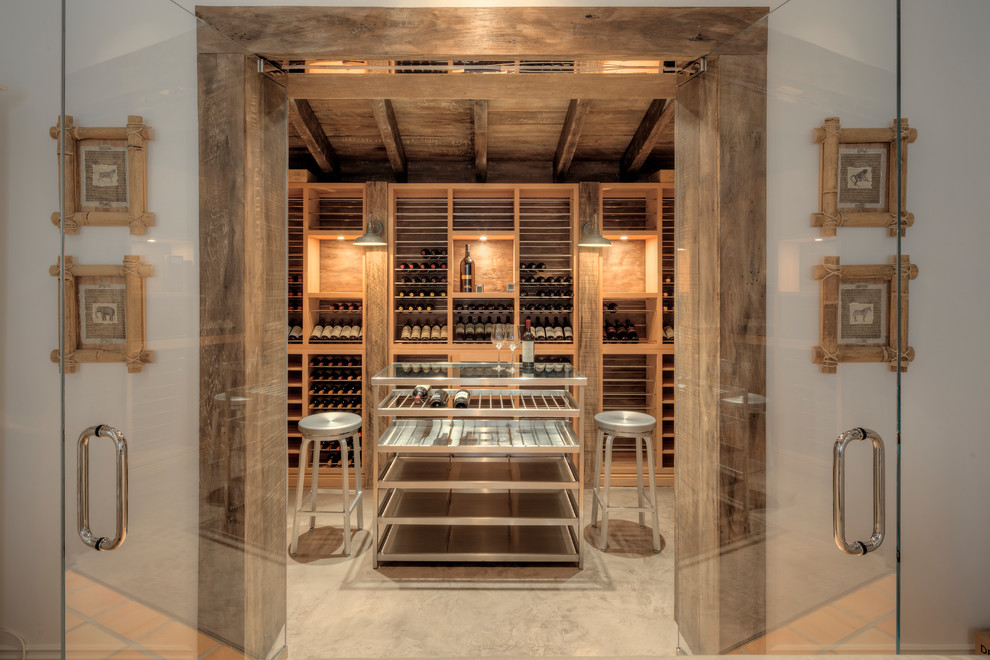 Mediterranean wine cellar in Miami with display racks and beige floor.