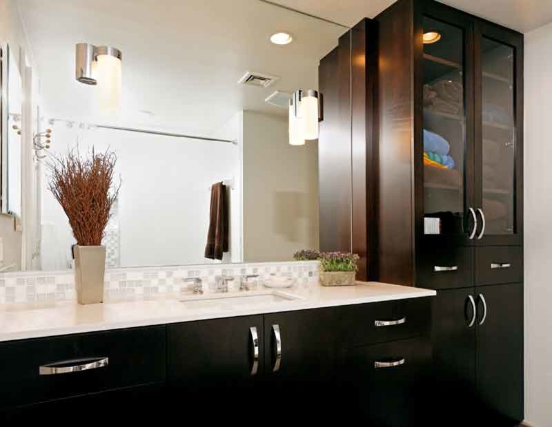 This is an example of a modern master bathroom in New York with glass-front cabinets, black cabinets, white tile, beige walls, a drop-in sink and engineered quartz benchtops.