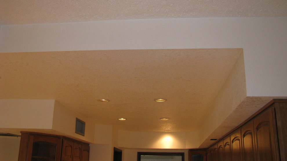 Example of a huge classic galley porcelain tile eat-in kitchen design in Phoenix with a double-bowl sink, raised-panel cabinets, dark wood cabinets, laminate countertops, beige backsplash, white appliances and an island