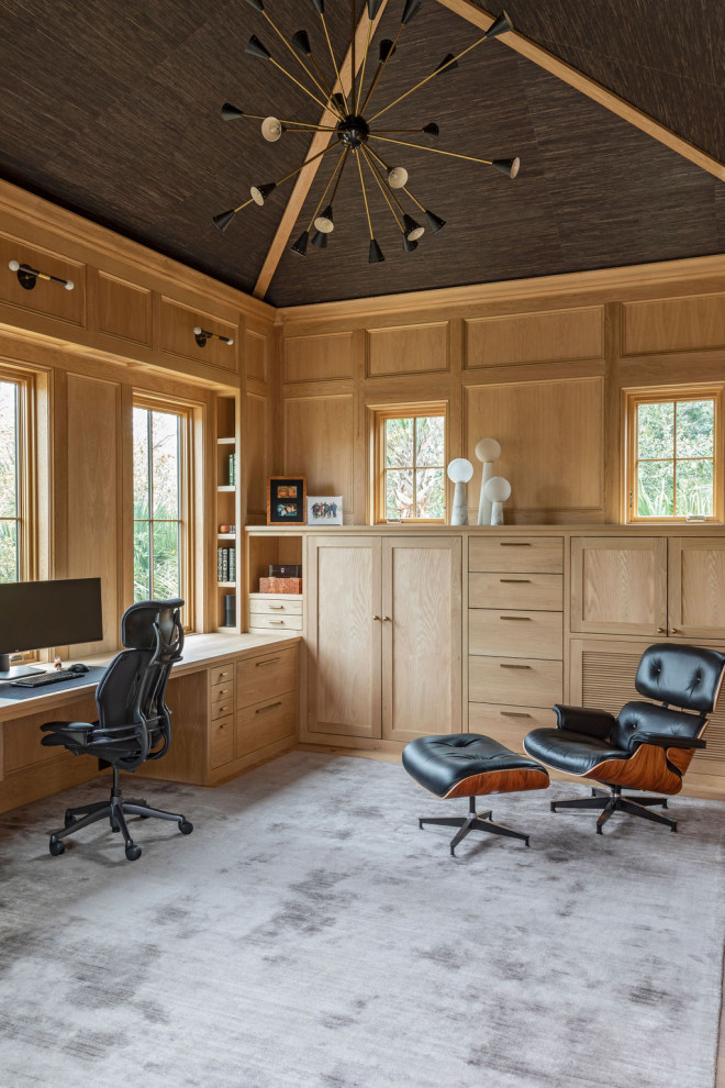 Large tuscan built-in desk vaulted ceiling study room photo in Charleston with brown walls