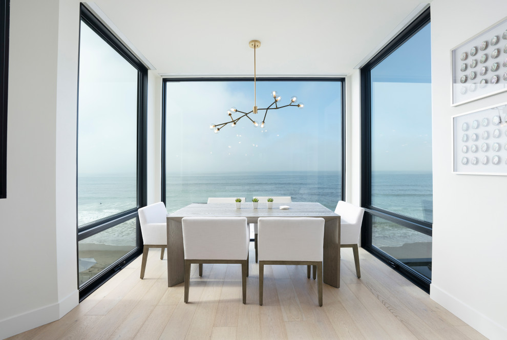 This is an example of a beach style dining room in San Diego.