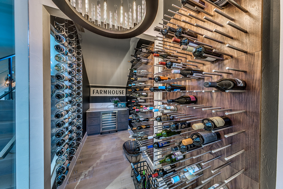Photo of a contemporary wine cellar in Oklahoma City with storage racks and light hardwood floors.
