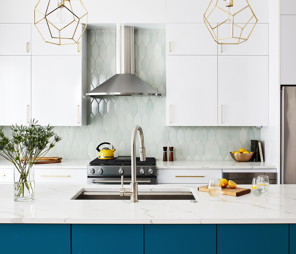 Contemporary kitchen in DC Metro with flat-panel cabinets, turquoise cabinets, green splashback, stainless steel appliances, light hardwood floors, with island and white benchtop.