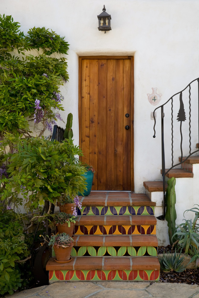 Inspiration for a mediterranean front door in Santa Barbara with a single front door and a medium wood front door.