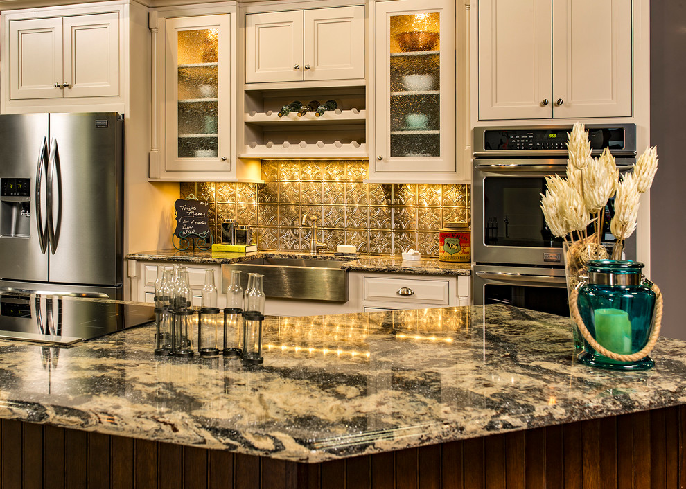 Kitchen - mid-sized traditional kitchen idea with a farmhouse sink, shaker cabinets, white cabinets, granite countertops, metallic backsplash, metal backsplash, stainless steel appliances and an island