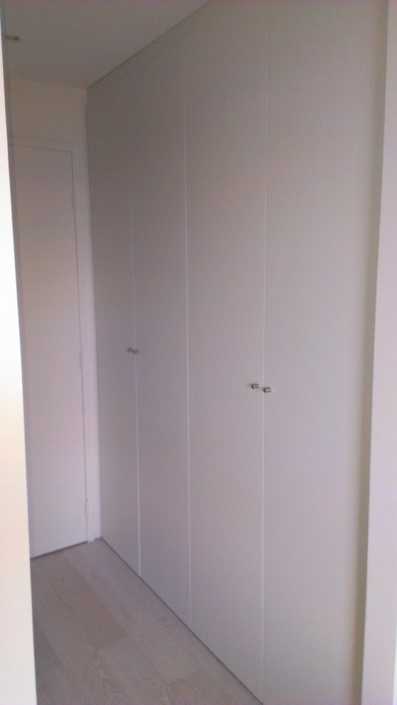 Photo of a modern women's built-in wardrobe in Marseille with beaded inset cabinets, beige cabinets and ceramic floors.