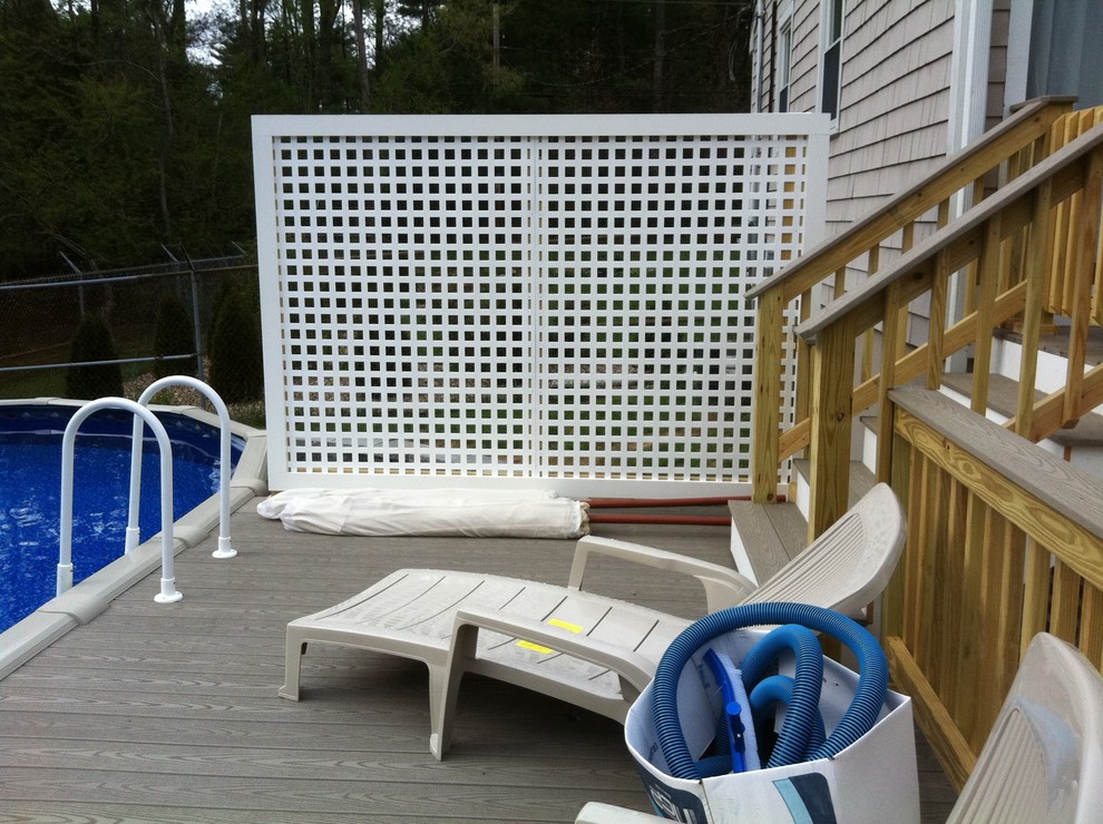 Example of a mid-sized backyard deck design in Boston with no cover