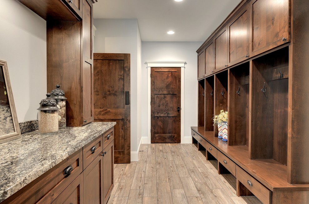 This is an example of a transitional mudroom in Minneapolis with white walls, ceramic floors and beige floor.